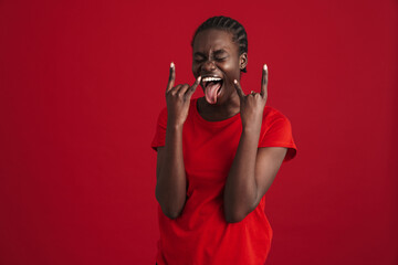 Young beautiful african woman with braided hair showing rock gesture