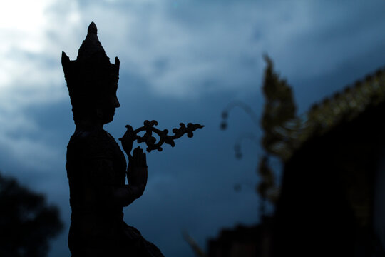 Silhouette of praying Thai angel statue