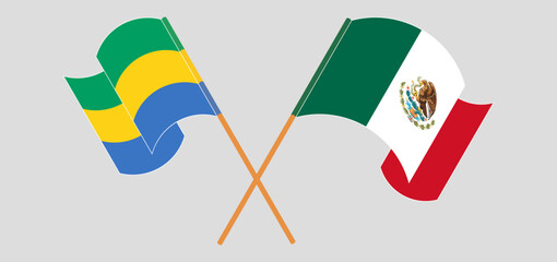 Crossed and waving flags of Gabon and Mexico