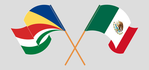 Crossed and waving flags of Seychelles and Mexico