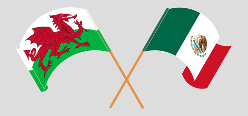 Crossed and waving flags of Wales and Mexico