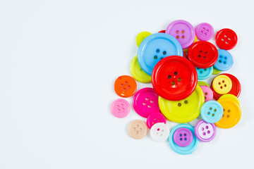 Brightly colored buttons on white background with copy space.