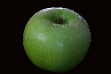 close up of granny smith with black background