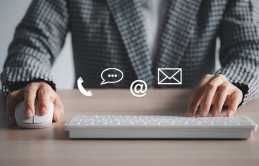 closeup woman using keyboard and mouse with phone, chat, address, mail icon above