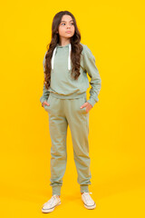 Fototapeta premium Sports studio portrait of teenager child wears sportswear. Teen girl is standing in sport outfit.