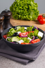 Fresh Greek salad with delicious rucola, spinach, arugula, feta cheese, cucumber, red onion and cherry tomato Healthy and diet food concept.