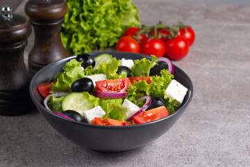 Fresh Greek salad with delicious rucola, spinach, arugula, feta cheese, cucumber, red onion and cherry tomato Healthy and diet food concept.