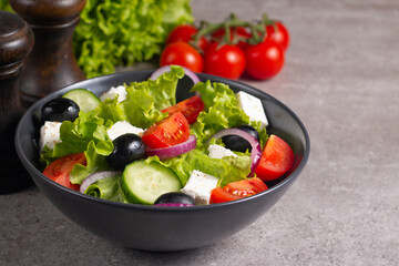 Fresh Greek salad with delicious rucola, spinach, arugula, feta cheese, cucumber, red onion and cherry tomato Healthy and diet food concept.
