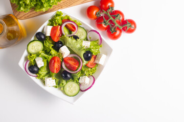 Fresh Greek salad with delicious rucola, spinach, arugula, feta cheese, cucumber, red onion and cherry tomato Healthy and diet food concept.