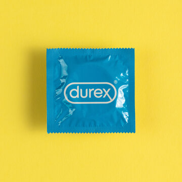 Lviv, Ukraine - August 02, 2022. Durex condom on yellow background. Top view.