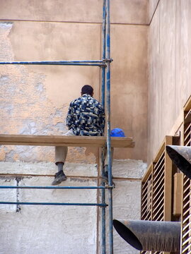 Man On Poorly Built Scaffolding In Use During The Construction Of The American Embassy In Baghdad, Iraq