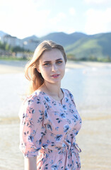 Portrait of beautiful Belarusian woman half Ukrainian in pink dress