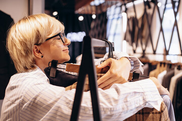 Woman tailor making measurements of mens wear