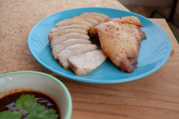 Roast pork and Thai Dipping Spicy Sauce on wooden table.Thailand street food.