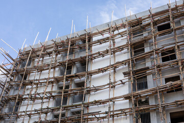 bamboo scaffolding for cement plastering in the construction of a new grand condominium