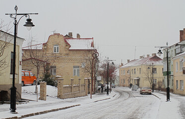 Winter view of Cathedral Street in the Old Town of Lutsk. Fresh snow is falling, Christmas time