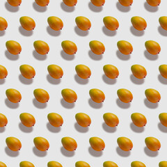 Fresh ripe fruits on color background. Pattern with mango on white background. Top view. Pop art design, creative summer food concept.