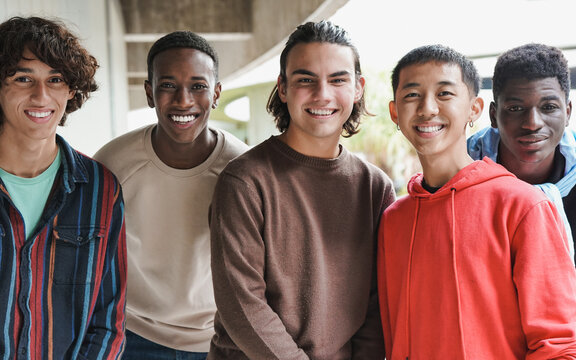 Group of happy multiethnic boys smiling on camera at school outdoor - Powered by Adobe