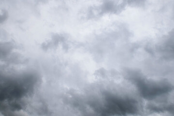 Storm clouds floating in a rainy day with natural light. Cloudscape scenery, overcast weather above blue sky. White and grey clouds scenic nature environment background