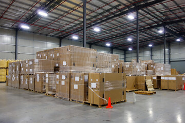 Interior of logistics warehouse with full of big cartons. - obrazy, fototapety, plakaty