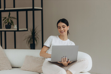 Girl working on laptop from home or student studying from home or freelancer. Or she is watching a video or using the Internet