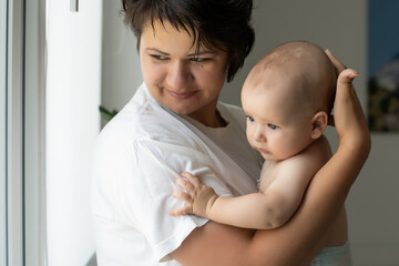 picture of happy mother with baby in hands
