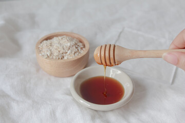 Natural ingredients for homemade face mask, oat and honey on white background, beauty skincare product concept,