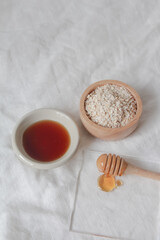 Natural ingredients for homemade face mask, oat and honey on white background, beauty skincare product concept,