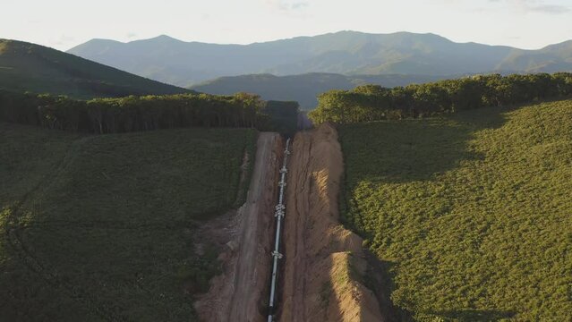 Laying the main gas pipe in a dug trench among the mountains