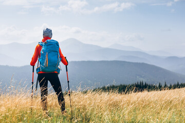 Hiker Young Woman With Backpack in the Mountain Top. Discovery Travel Destination Concept