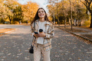Fototapeta premium attractive young woman walking in autumn wearing jacket