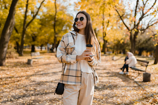 attractive young woman walking in autumn wearing jacket