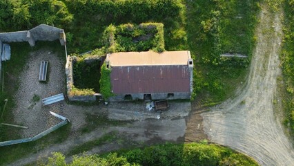 Aerial view of old abandoned stone farmhouse in the Irish countryside