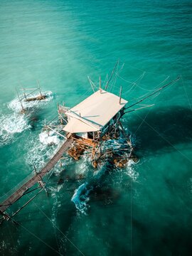 Aerial view of traditional fishing bagang over turquoise sea