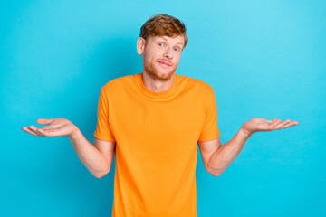 Photo of unsure red hair guy shrug shoulders wear orange t-shirt isolated on teal color background