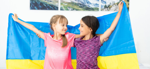 children carry fluttering flag of Ukraine. Ukraines Independence Day. Flag Day. Constitution day. Girls with flag of Ukraine - obrazy, fototapety, plakaty