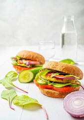 Vegan lentil burgers with kale and tomato sauce on a white background. Plant based food concept.