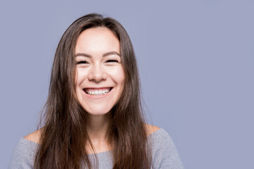 Young positive girl with dark long hair