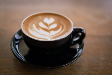 Hot coffee Latte art on wooden table