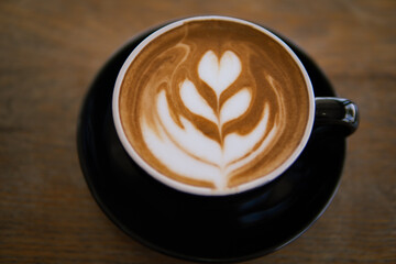 Hot coffee Latte art on wooden table