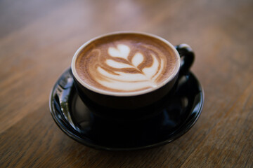 Hot coffee Latte art on wooden table