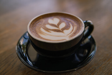 Hot coffee Latte art on wooden table