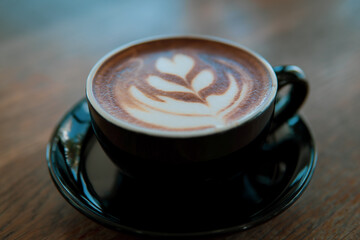 Hot coffee Latte art on wooden table
