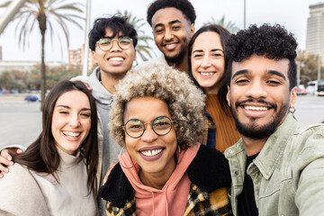 Multiracial group of young friends taking selfie portrait together outdoor - Millennial diverse...