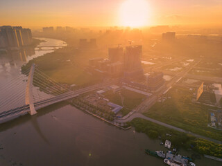 Fototapeta premium Aerial view of Ho Chi Minh City skyline and skyscrapers on Saigon river, center of heart business at downtown. Morning view. Far away is Landmark 81 skyscraper