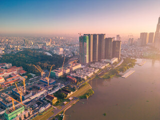 Fototapeta na wymiar Aerial view of Ho Chi Minh City skyline and skyscrapers on Saigon river, center of heart business at downtown. Morning view. Far away is Landmark 81 skyscraper