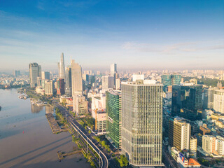 Obraz premium Aerial view of Ho Chi Minh City skyline and skyscrapers on Saigon river, center of heart business at downtown. Morning view. Far away is Landmark 81 skyscraper
