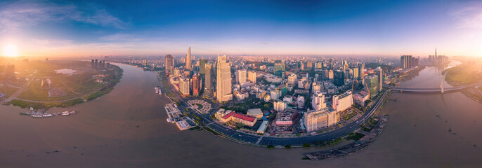 Fototapeta premium Aerial view of Ho Chi Minh City skyline and skyscrapers on Saigon river, center of heart business at downtown. Morning view. Far away is Landmark 81 skyscraper