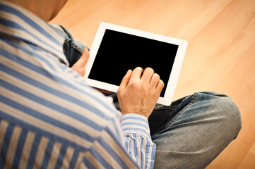 man holding a computer tablet with blank screen