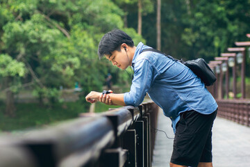 Asian man listening music and chill out on the bridge